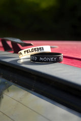 Černý a bílý náramek I Need Money for Felcedes na střeše červené Felicie